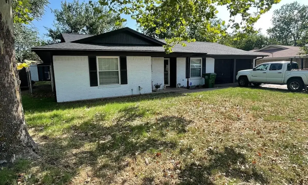 Professional roofing crew working on a residential roof in Pepperell